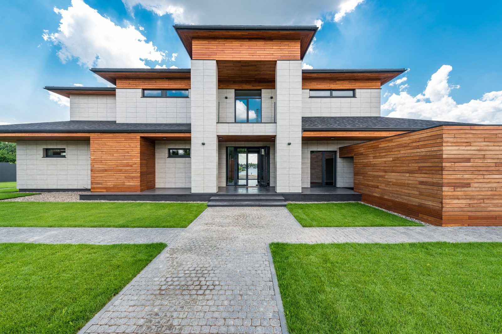 A contemporary house with a dark glazed aluminium entrance door